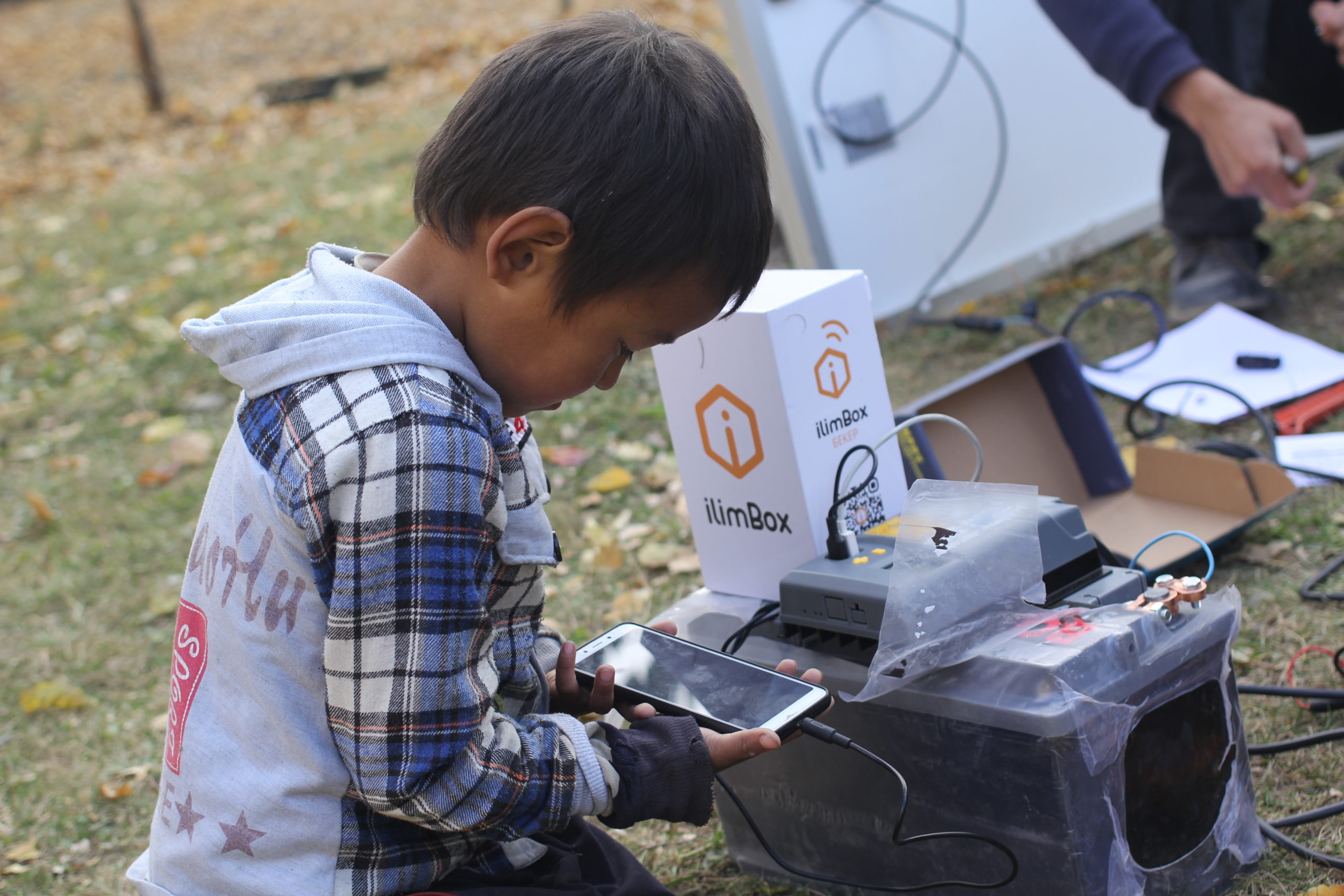 Boy watching a video on phone via Internet in a Box